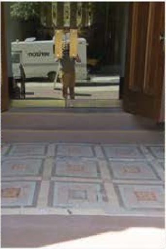 Encaustic tile flooring in the entryway before restoration